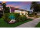 House exterior at dusk, showcasing landscaping and warm lighting at 1923 Hibiscus St, Sarasota, FL 34239