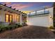 Front exterior of home at sunset, showcasing brick driveway at 1923 Hibiscus St, Sarasota, FL 34239