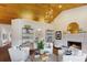 Living room with vaulted wood ceilings, fireplace, and white sofas at 1923 Hibiscus St, Sarasota, FL 34239