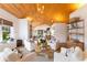 Bright living room with vaulted wood ceilings, comfy seating, and a wood-burning fireplace at 1923 Hibiscus St, Sarasota, FL 34239