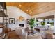 Living room with wood-beamed ceiling, fireplace, and comfortable seating at 1923 Hibiscus St, Sarasota, FL 34239