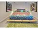 Bedroom with platform bed and colorful bedding at 315 Palmetto W Rd, Nokomis, FL 34275