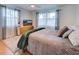 Comfortable bedroom with a king bed and dresser at 315 Palmetto W Rd, Nokomis, FL 34275