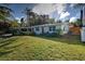 Modern home with orange door and lush green lawn at 315 Palmetto W Rd, Nokomis, FL 34275