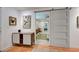 Hallway with barn door and view into bedroom at 315 Palmetto W Rd, Nokomis, FL 34275