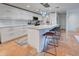 Modern white kitchen with island, quartz countertops, and stylish pendant lights at 315 Palmetto W Rd, Nokomis, FL 34275