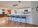 Modern white kitchen with island, quartz countertops, and stylish pendant lights at 315 Palmetto W Rd, Nokomis, FL 34275