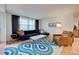 Living room with blue sofa and terracotta tile floors at 315 Palmetto W Rd, Nokomis, FL 34275