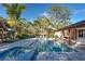 Inviting pool and spa surrounded by tropical landscaping, with patio furniture at 315 Palmetto W Rd, Nokomis, FL 34275