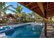 Stunning pool area with tiki bar and lush tropical landscaping at 315 Palmetto W Rd, Nokomis, FL 34275