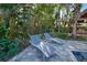 Relaxing poolside lounge chairs under shade of palm trees at 315 Palmetto W Rd, Nokomis, FL 34275