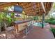 Rustic tiki bar with thatched roof and tropical decor at 315 Palmetto W Rd, Nokomis, FL 34275