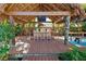 Covered tiki bar with seating, perfect for entertaining at 315 Palmetto W Rd, Nokomis, FL 34275