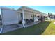 Mobile home with covered patio, parking, and landscaped yard at 3333 26Th E Ave # 1107, Bradenton, FL 34208