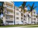 Building exterior featuring three-story, light-yellow building with balconies and palm trees at 3431 79Th Street W Cir # 102, Bradenton, FL 34209