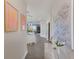 Long hallway with modern wall art and views into living and kitchen areas at 3431 79Th Street W Cir # 102, Bradenton, FL 34209