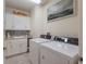 Laundry room with white cabinets and washer/dryer at 3431 79Th Street W Cir # 102, Bradenton, FL 34209