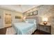 Main bedroom with stone wall, king size bed and ensuite bath access at 3625 Tin Cup Blvd, Sarasota, FL 34232