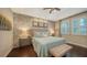 Bright main bedroom with stone accent wall, comfy bed, and ensuite bath at 3625 Tin Cup Blvd, Sarasota, FL 34232