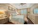 Main bedroom with stone accent wall, king bed and ensuite bath at 3625 Tin Cup Blvd, Sarasota, FL 34232