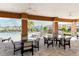 Covered patio area with tables and chairs near the pool at 3625 Tin Cup Blvd, Sarasota, FL 34232