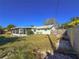 Backyard view showcasing a large grassy area and screened porch at 4001 17Th W Ave, Bradenton, FL 34205