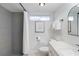 Modern bathroom with gray tile shower and white vanity at 5310 Gulf Of Mexico Dr # 11, Longboat Key, FL 34228