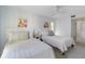 Guest bedroom with two twin beds and a ceiling fan at 5310 Gulf Of Mexico Dr # 11, Longboat Key, FL 34228