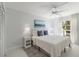 Well-lit bedroom with a queen bed, nightstands, and access to a balcony at 5310 Gulf Of Mexico Dr # 11, Longboat Key, FL 34228