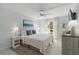 Bright bedroom with a queen-size bed and access to a balcony at 5310 Gulf Of Mexico Dr # 11, Longboat Key, FL 34228