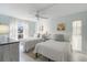 Guest bedroom with twin beds, nightstands, and plenty of natural light at 5310 Gulf Of Mexico Dr # 11, Longboat Key, FL 34228