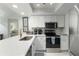 Modern kitchen with white cabinets, stainless steel appliances, and quartz countertops at 5310 Gulf Of Mexico Dr # 11, Longboat Key, FL 34228