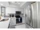 Modern kitchen with stainless steel appliances and white cabinets at 5310 Gulf Of Mexico Dr # 11, Longboat Key, FL 34228