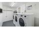 Clean laundry room with two sets of modern washer and dryer at 5310 Gulf Of Mexico Dr # 11, Longboat Key, FL 34228