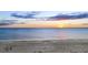 Stunning sunset over tranquil ocean waves and sandy beach at 5965 Gulf Of Mexico Dr, Longboat Key, FL 34228