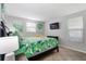 Bright bedroom with leafy bedding and a mounted TV at 6201 34Th W Ave, Bradenton, FL 34209