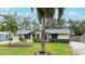 House with gray exterior, palm trees, and well-manicured lawn at 6201 34Th W Ave, Bradenton, FL 34209