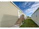 Back entrance features a small set of wooden steps leading to the door at 6824 Haawi Ct, North Port, FL 34287