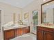 Spa-like bathroom with soaking tub, double vanity, and private access to backyard at 749 Freeling Dr, Sarasota, FL 34242