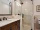 Bathroom with glass shower and dark wood vanity at 749 Freeling Dr, Sarasota, FL 34242