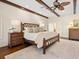 Relaxing main bedroom with hardwood floors, a ceiling fan and en-suite bathroom at 749 Freeling Dr, Sarasota, FL 34242