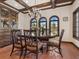 Formal dining room with a wooden table, chairs, built-in cabinetry, and arched windows at 749 Freeling Dr, Sarasota, FL 34242