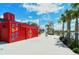 Modern community building with red exterior and blue accents at 12140 Wellen Golf St # 404, Venice, FL 34293