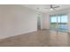 Spacious living area with tile floors and access to a balcony at 12140 Wellen Golf St # 404, Venice, FL 34293