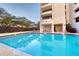 Inviting community pool with lounge chairs and patio area at 1255 N Gulfstream Ave # Ph1501, Sarasota, FL 34236