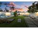 Serene backyard view at sunset with pool and patio at 2069 Bougainvillea St, Sarasota, FL 34239
