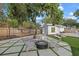 Relaxing backyard with firepit and seating under a tree at 2069 Bougainvillea St, Sarasota, FL 34239