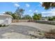 Large backyard with gravel parking and wooden fence at 2069 Bougainvillea St, Sarasota, FL 34239