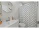 Clean bathroom with white vanity, shower, and patterned curtain at 2069 Bougainvillea St, Sarasota, FL 34239