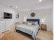 Spacious bedroom with a king-size bed, dresser, and light wood floors at 2069 Bougainvillea St, Sarasota, FL 34239